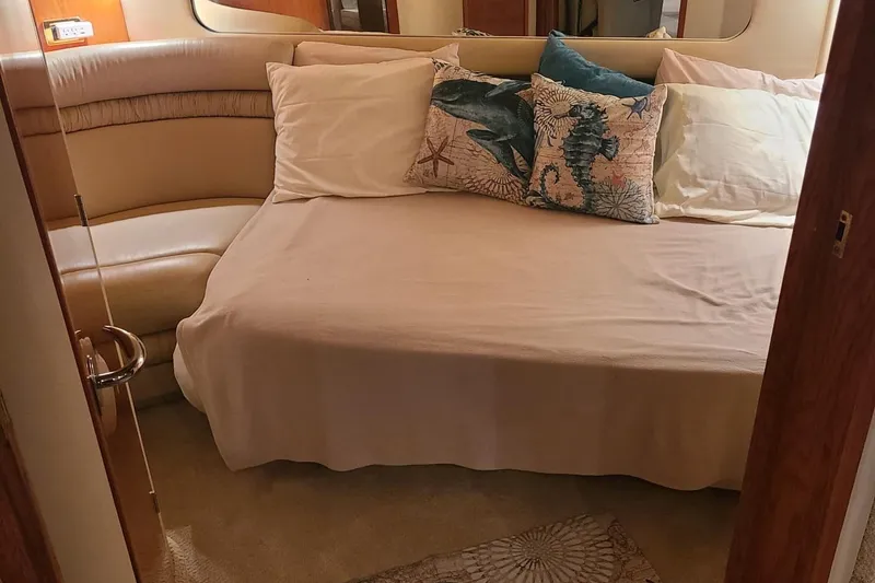 Slide: The Image of Interior cabin of 2001 Sea Ray Sundancer 460 with cozy bed and nautical-themed pillows. - 45