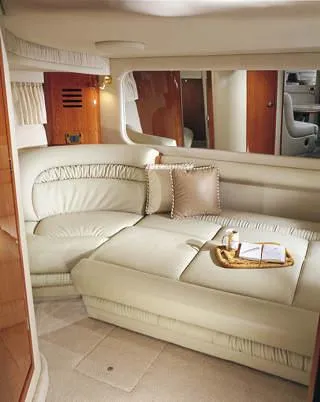 Slide: The Image of 2001 Sea Ray Sundancer 460 yacht docked on a serene lake with lush green hills. - 5