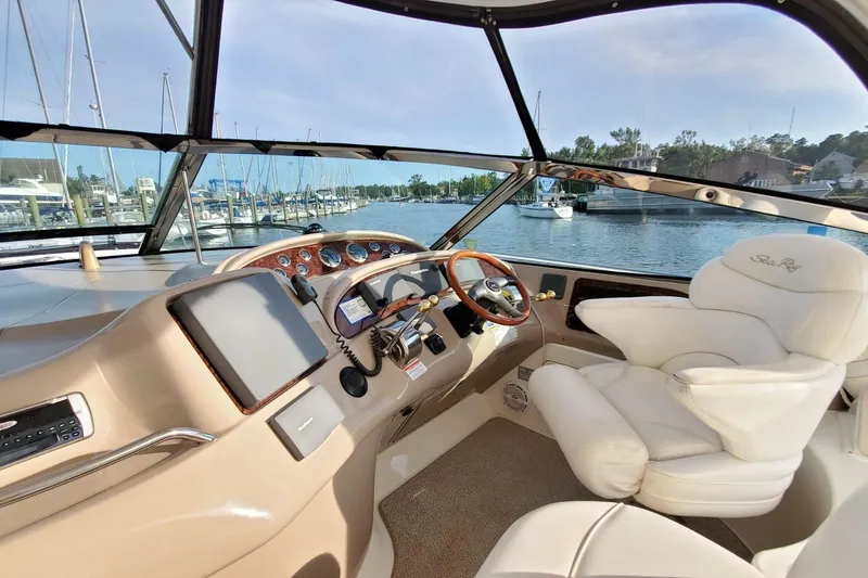 Slide: The Image of 2001 Sea Ray Sundancer 460 helm with luxurious seating and marina view. - 9
