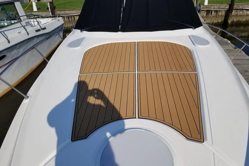 Slide: The Image of 2003 Cruisers Yachts 3470 Express boat deck with teak-style flooring. - 14