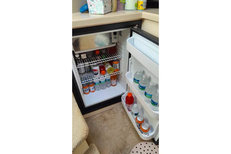 Slide: The Image of Mini fridge stocked with beverages inside a 2003 Cruisers Yachts 3470 Express. - 20