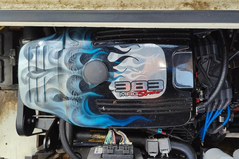 Slide: The Image of Engine of 2003 Cruisers Yachts 3470 Express with custom flame design and "383 Mag Stroker" label. - 28