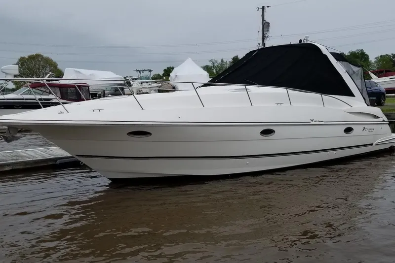 Slide: The Image of 2003 Cruisers Yachts 3470 Express docked on calm water. - 3