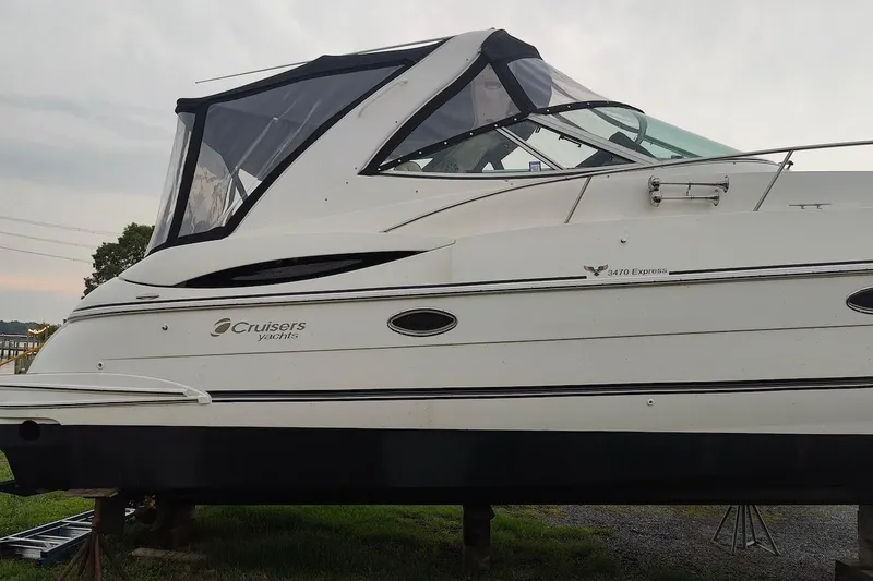 Slide: The Image of 2003 Cruisers Yachts 3470 Express boat on land, side view. - 7