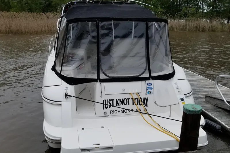 Slide: The Image of 2003 Cruisers Yachts 3470 Express docked, rear view with "Just Knot Today" name. - 12