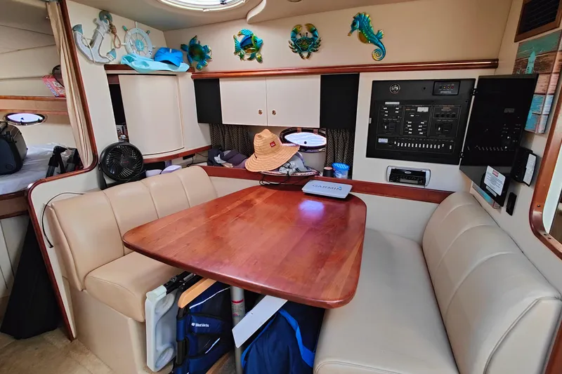 Slide: The Image of Interior of 2003 Cruisers Yachts 3470 Express with dining area and control panel. - 17
