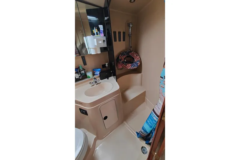 Slide: The Image of Bathroom of 2003 Cruisers Yachts 3470 Express with sink, shower, and storage. - 24