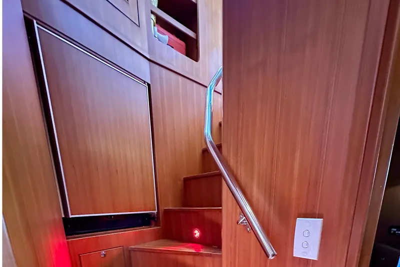 Slide: The Image of Staircase with wooden paneling and metal handrail inside a 2003 Nordhavn 47 yacht. - 13