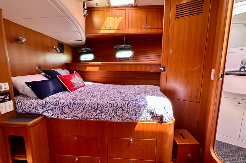 Slide: The Image of Cozy cabin interior of 2003 Nordhavn 47 yacht with wood paneling and nautical decor. - 16
