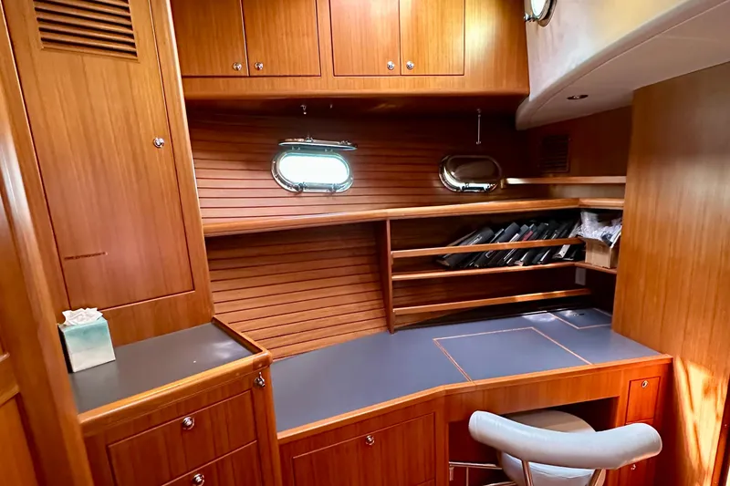 Slide: The Image of Luxurious wooden interior of 2003 Nordhavn 47 yacht with desk and storage shelves. - 17
