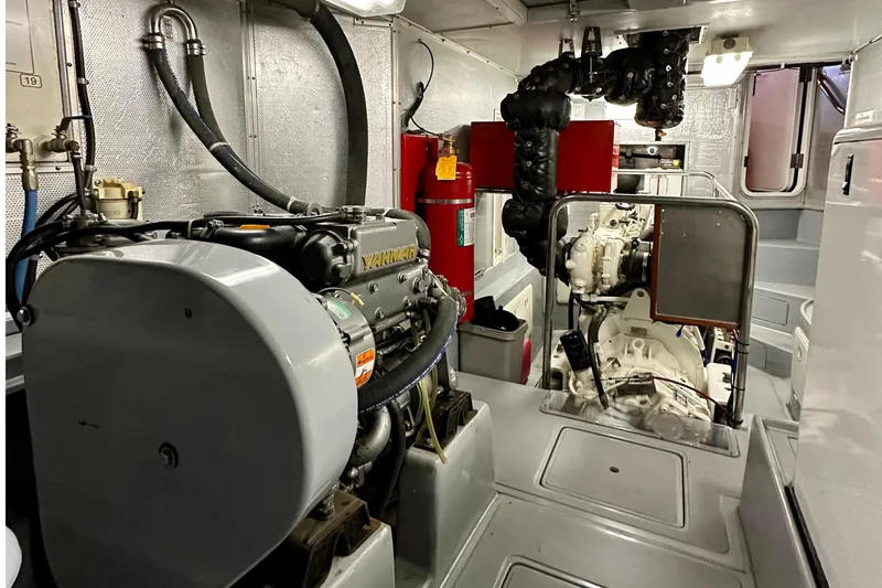 Slide: The Image of Engine room of a 2003 Nordhavn 47 yacht, featuring Yanmar engine and equipment. - 21