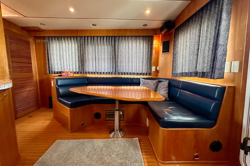 Slide: The Image of Luxurious 2003 Nordhavn 47 yacht interior with cozy dining area and elegant wood finish. - 7
