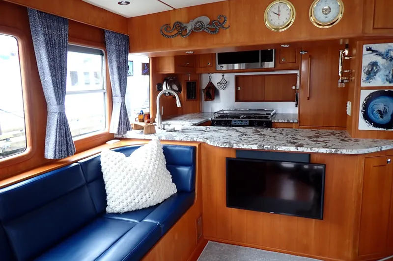 Slide: The Image of Luxurious 2003 Nordhavn 47 yacht interior with modern kitchen and cozy seating area. - 8
