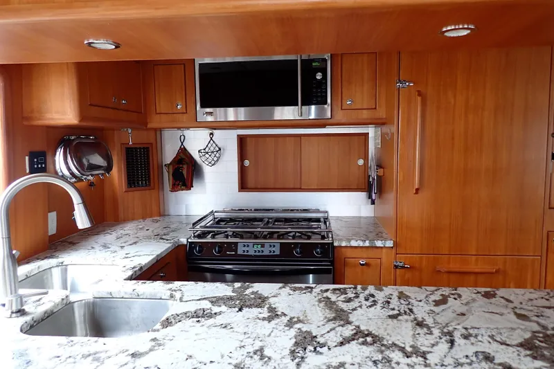 Slide: The Image of Luxurious 2003 Nordhavn 47 yacht kitchen with granite countertops and modern appliances. - 9