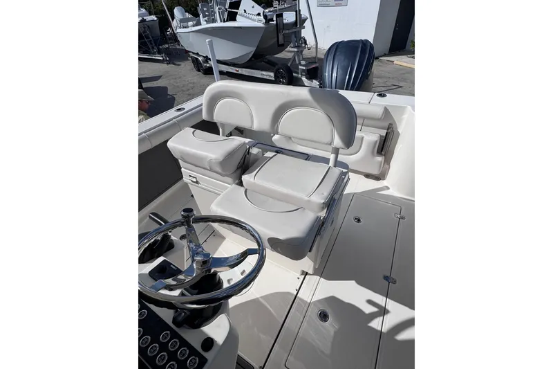 Slide: The Image of 2025 Sea Born SX239 Offshore boat interior with steering wheel and seating. - 19