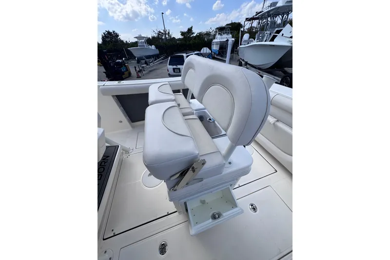 Slide: The Image of 2025 Sea Born SX239 Offshore boat interior with white cushioned seating. - 22