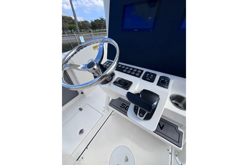 Slide: The Image of 2025 Sea Born SX239 Offshore boat helm with steering wheel and control panel. - 24