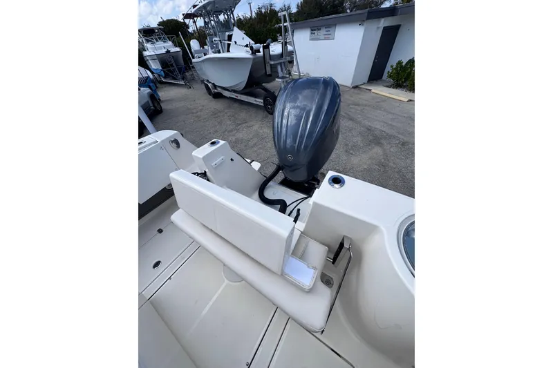 Slide: The Image of 2025 Sea Born SX239 Offshore boat with outboard motor, docked at marina. - 25