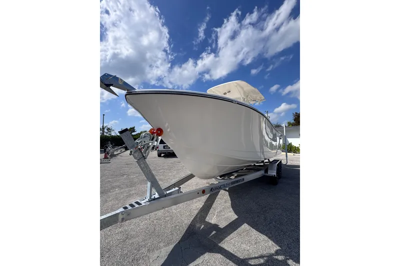 Slide: The Image of 2025 Sea Born SX239 Offshore boat on trailer under blue sky. - 3