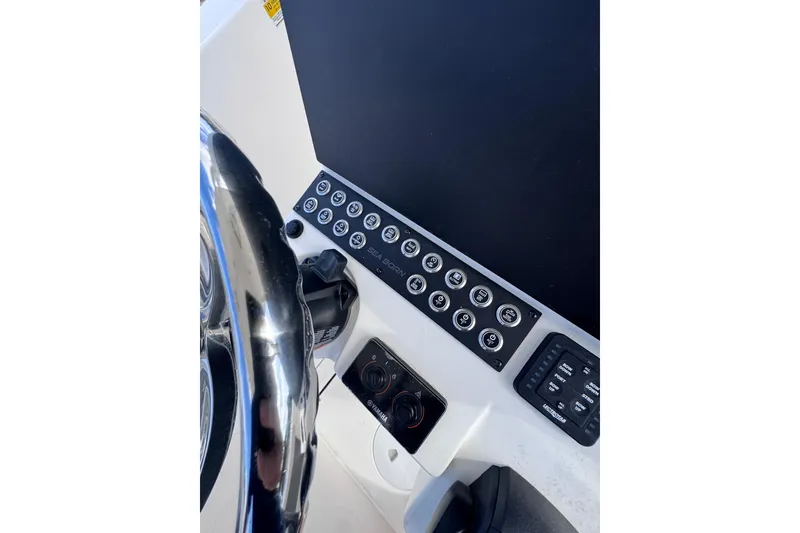 Slide: The Image of 2025 Sea Born SX239 Offshore boat dashboard with steering wheel and control panel. - 33