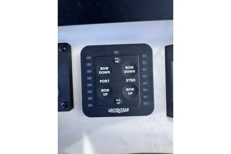 Slide: The Image of Control panel of 2025 Sea Born SX239 Offshore boat with Lectrotab trim tab switches. - 35