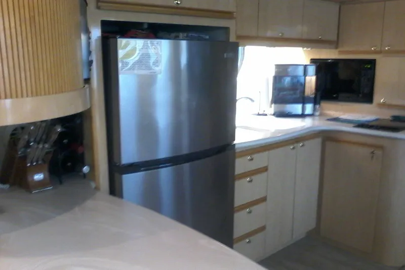 Slide: The Image of Modern kitchen interior on a 2000 Bluewater 5800 Millenium yacht, featuring stainless steel appliances. - 10