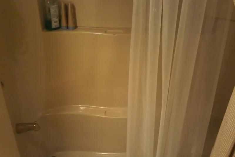 Slide: The Image of Shower area with curtain and toiletries on a Bluewater 5800 Millenium yacht, 2000 model. - 17