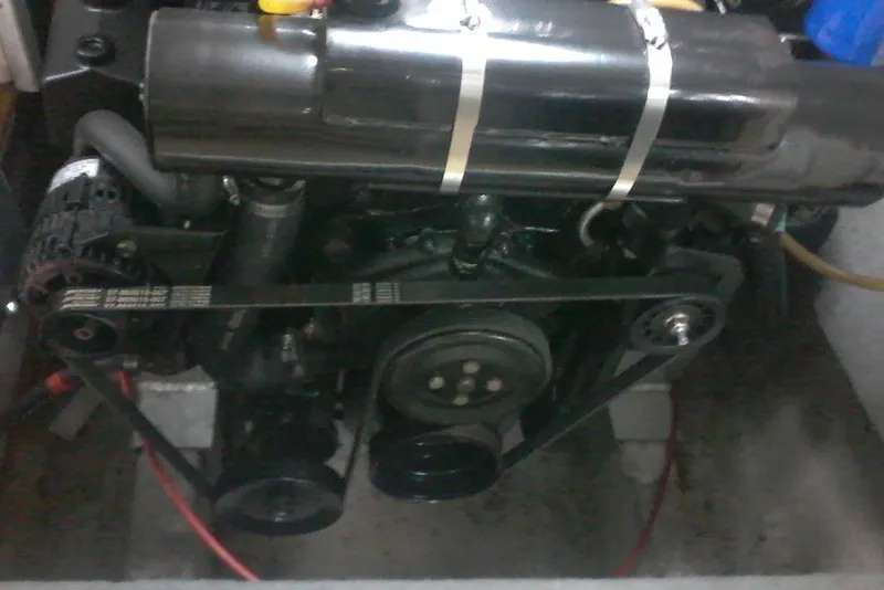 Slide: The Image of Engine compartment of a 2000 Bluewater 5800 Millenium boat, showing belts and components. - 24