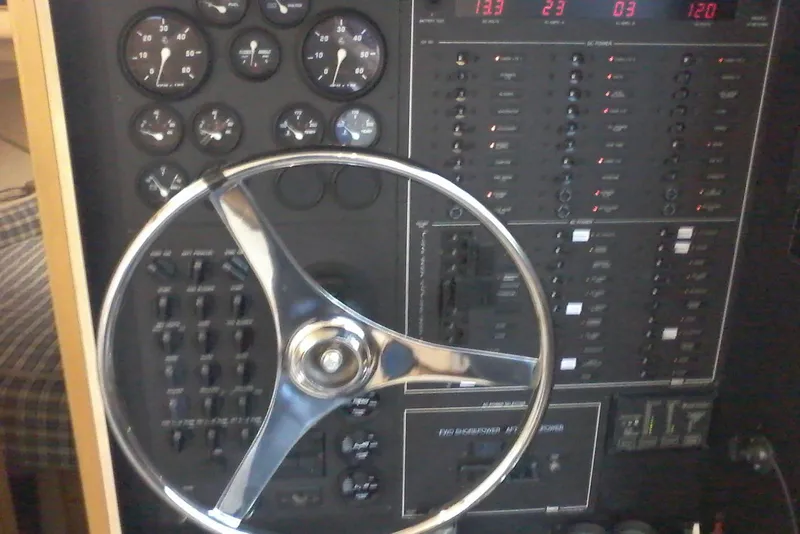 Slide: The Image of Control panel of a 2000 Bluewater 5800 Millenium boat with steering wheel and gauges. - 26