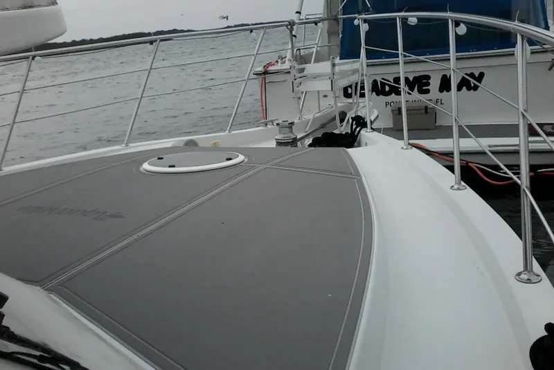 Slide: The Image of 2000 Bluewater 5800 Millenium yacht on water, featuring sleek deck design. - 27