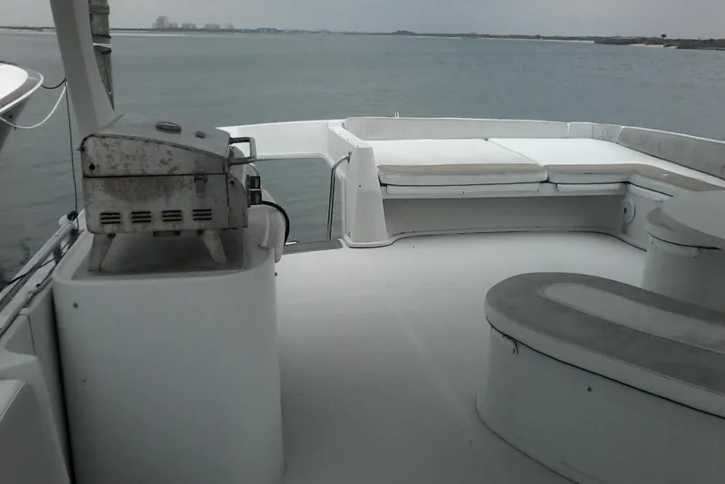 Slide: The Image of Spacious deck of 2000 Bluewater 5800 Millenium yacht with seating and grill. - 31