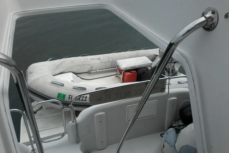Slide: The Image of Inflatable boat docked on a 2000 Bluewater 5800 Millenium yacht, viewed from the deck. - 34