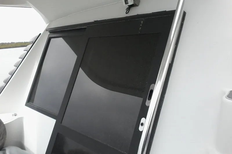 Slide: The Image of Sliding door on a 2000 Bluewater 5800 Millenium yacht, featuring sleek black panels. - 35