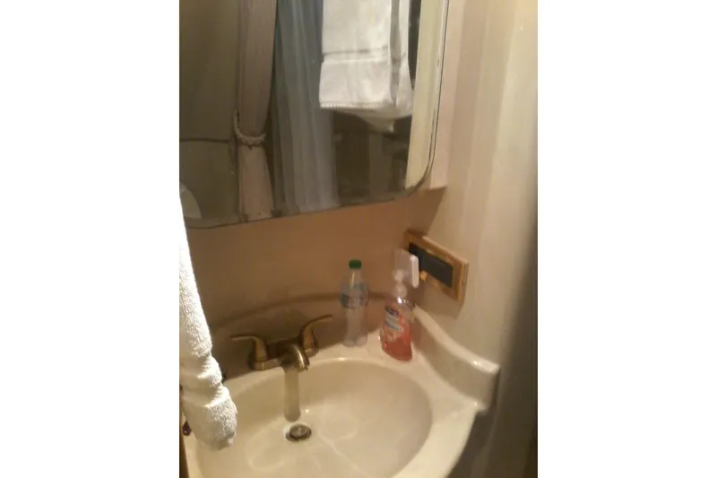 Slide: The Image of Compact bathroom sink area in 2000 Bluewater 5800 Millenium yacht. - 7