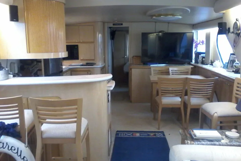 Slide: The Image of Interior of 2000 Bluewater 5800 Millenium yacht with modern furnishings and large TV. - 9