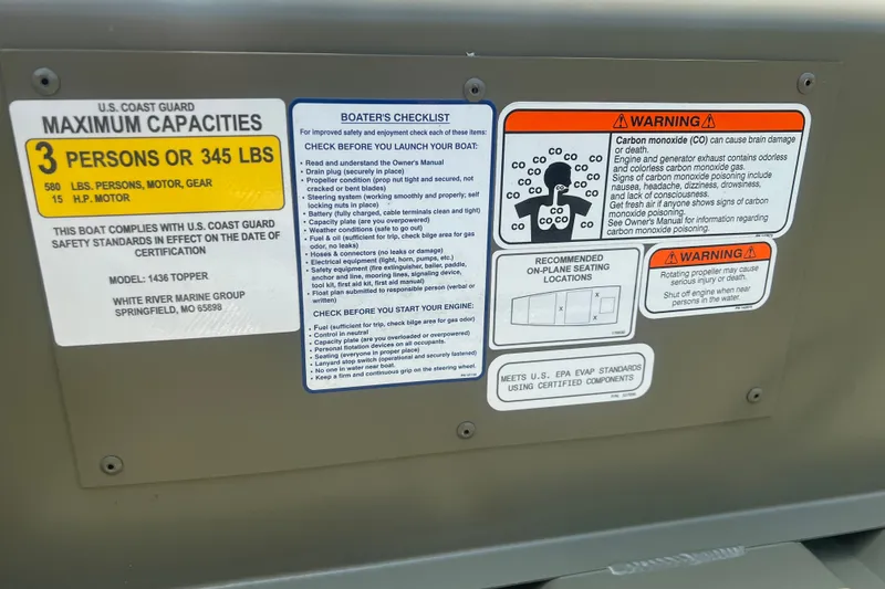 Slide: The Image of Boat safety and capacity labels on a 2026 Tracker Grizzly 14 Jon. - 11