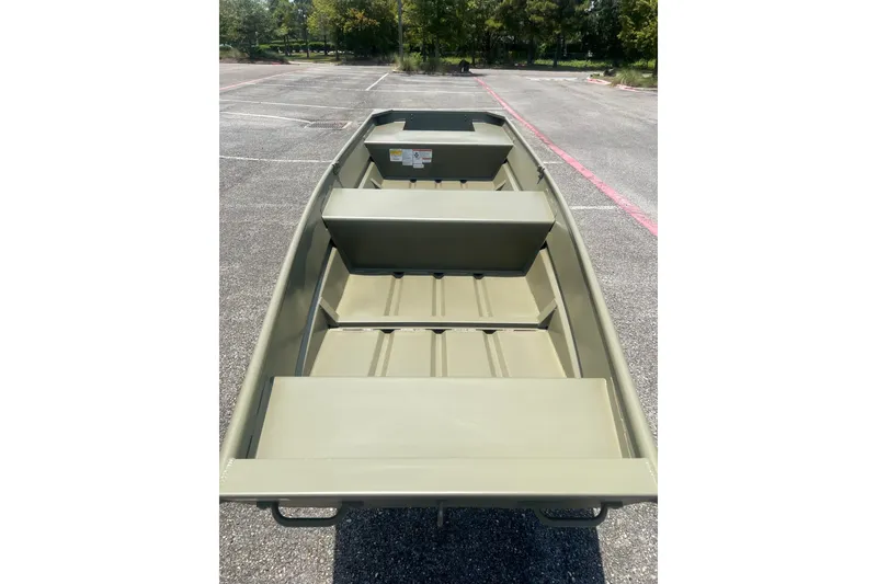 Slide: The Image of 2026 Tracker Grizzly 14 Jon boat in a parking lot, showcasing its spacious interior design. - 5