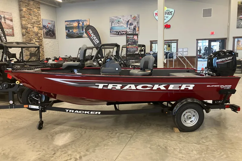 The Image of 2026 Tracker Super Guide V-16 SC boat displayed indoors with Mercury engine. - 0