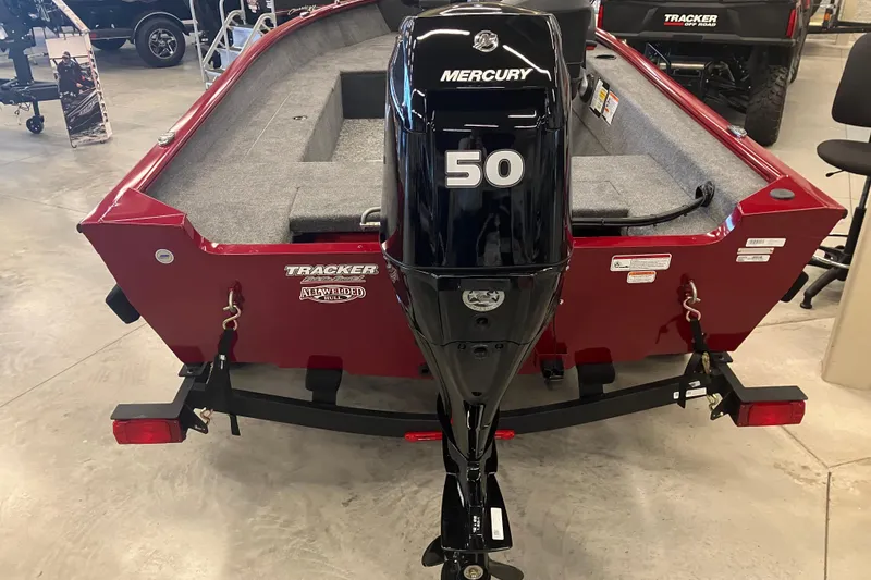 Slide: The Image of 2026 Tracker Super Guide V-16 SC boat with Mercury 50 engine in showroom. - 2