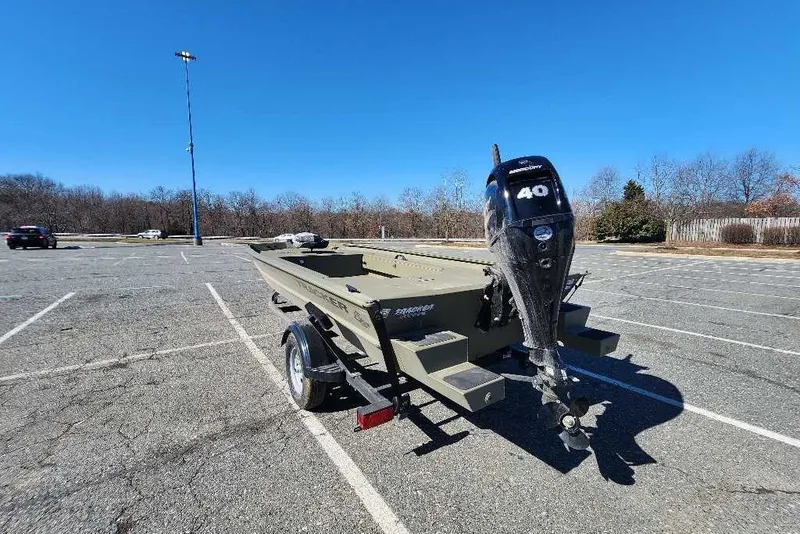 Slide: The Image of 2026 Tracker Grizzly 1654 T Sportsman boat on trailer in parking lot. - 43