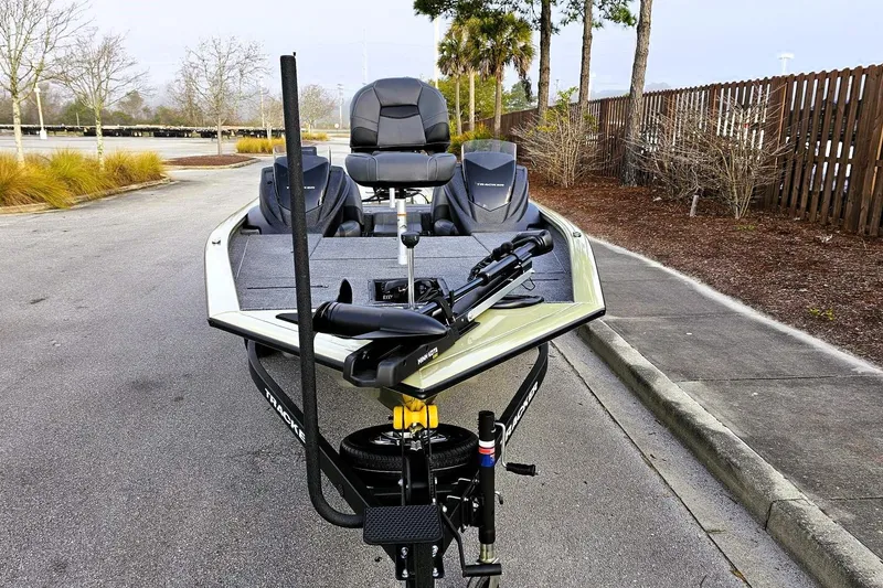 Slide: The Image of 2026 Tracker Pro Team 195 boat on trailer, parked on a paved road. - 5