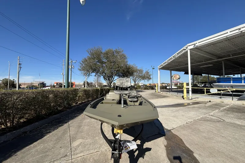 The Image of 2026 Tracker Grizzly 1754 SC boat parked outdoors under clear blue sky. - 0