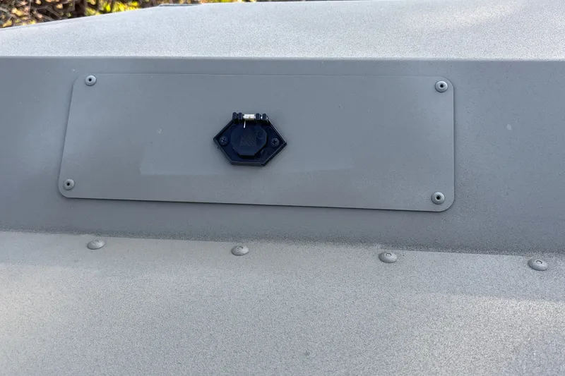 Slide: The Image of 2026 Tracker Grizzly 1754 SC boat detail with mounted hardware on gray surface. - 16