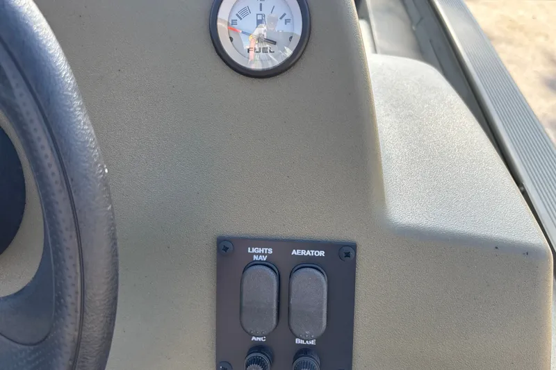 Slide: The Image of Dashboard of 2026 Tracker Grizzly 1754 SC with fuel gauge and control switches. - 14