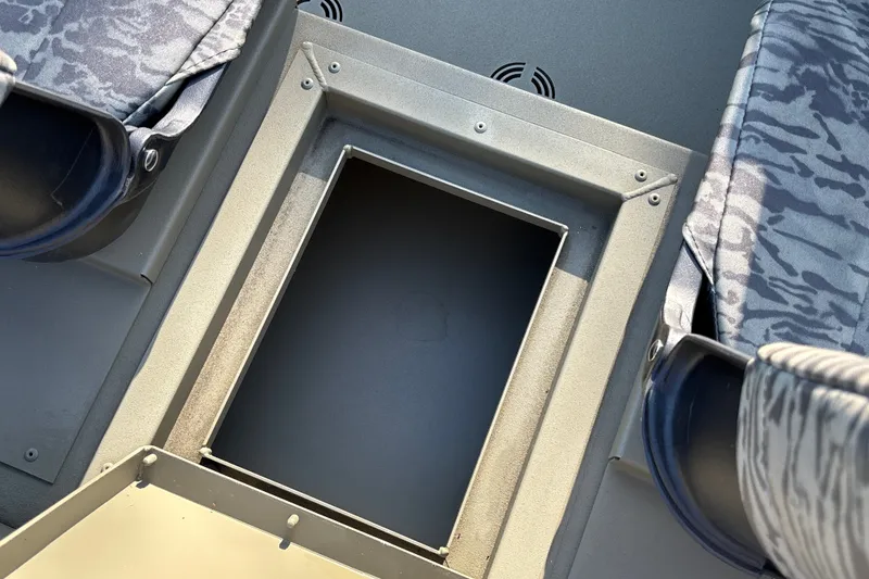 Slide: The Image of 2026 Tracker Grizzly 1754 SC boat interior with open storage compartment. - 19