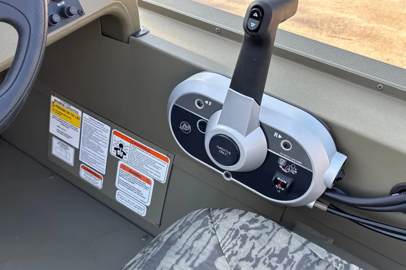 Slide: The Image of Control panel of 2026 Tracker Grizzly 1754 SC boat with throttle and warning labels. - 15