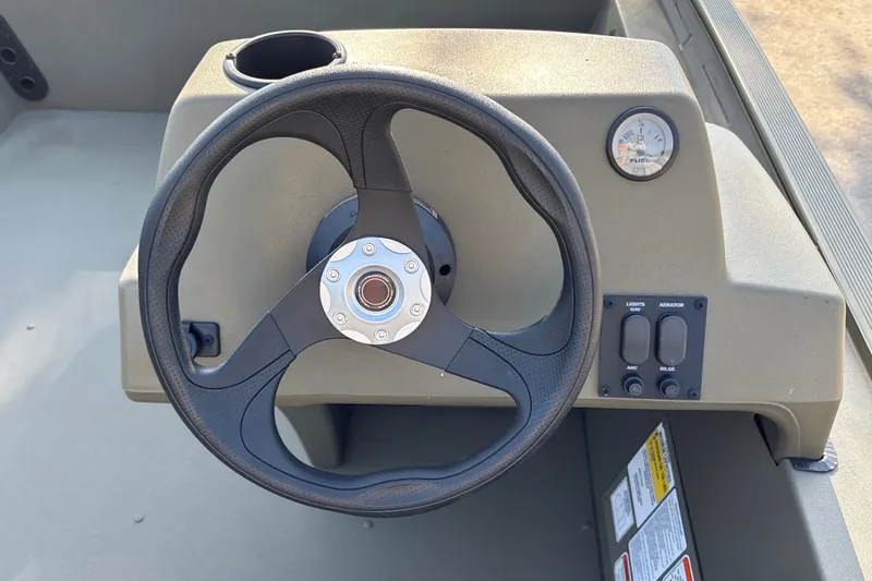 Slide: The Image of Steering console of 2026 Tracker Grizzly 1754 SC boat with gauge and controls. - 13