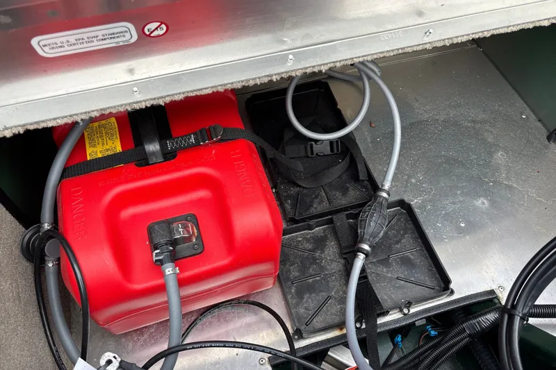 Slide: The Image of Fuel tank and hoses in a 2026 Tracker Bass Tracker Classic Limited boat. - 18
