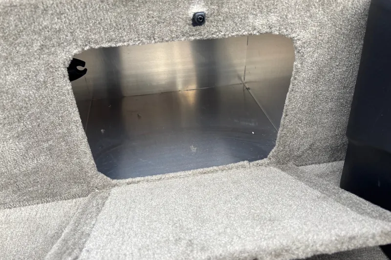 Slide: The Image of Carpeted storage compartment in 2026 Tracker Bass Tracker Classic Limited boat. - 16