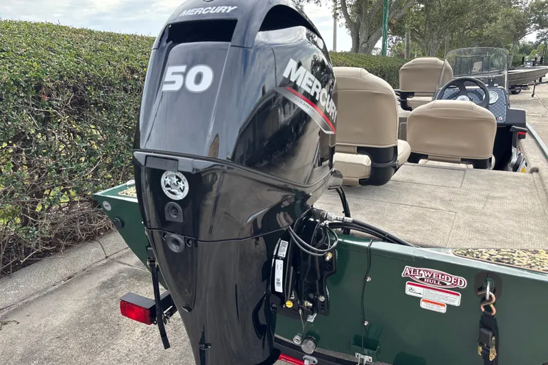 Slide: The Image of 2026 Tracker Bass Tracker Classic Limited with Mercury 50 outboard motor, parked outdoors. - 20